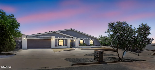 view of front of home with concrete driveway and an attached garage