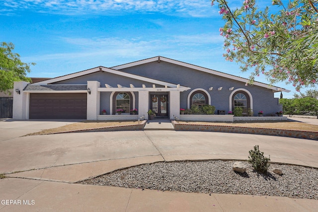 single story home featuring brick siding, driveway, and a garage