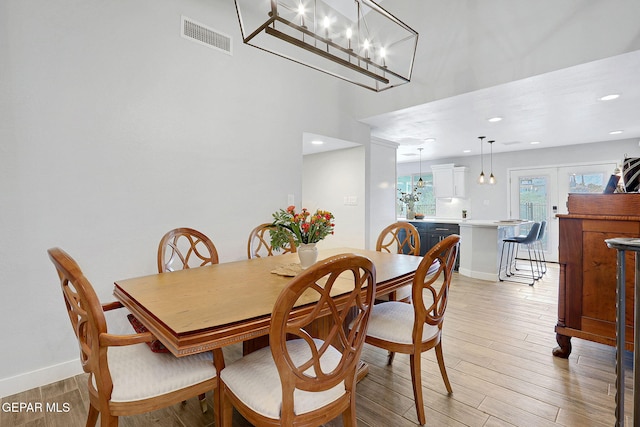 dining area featuring light wood-style flooring, baseboards, and recessed lighting