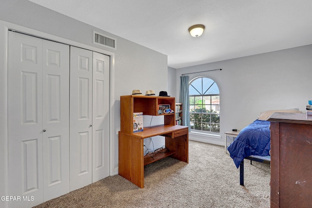 carpeted bedroom with a closet