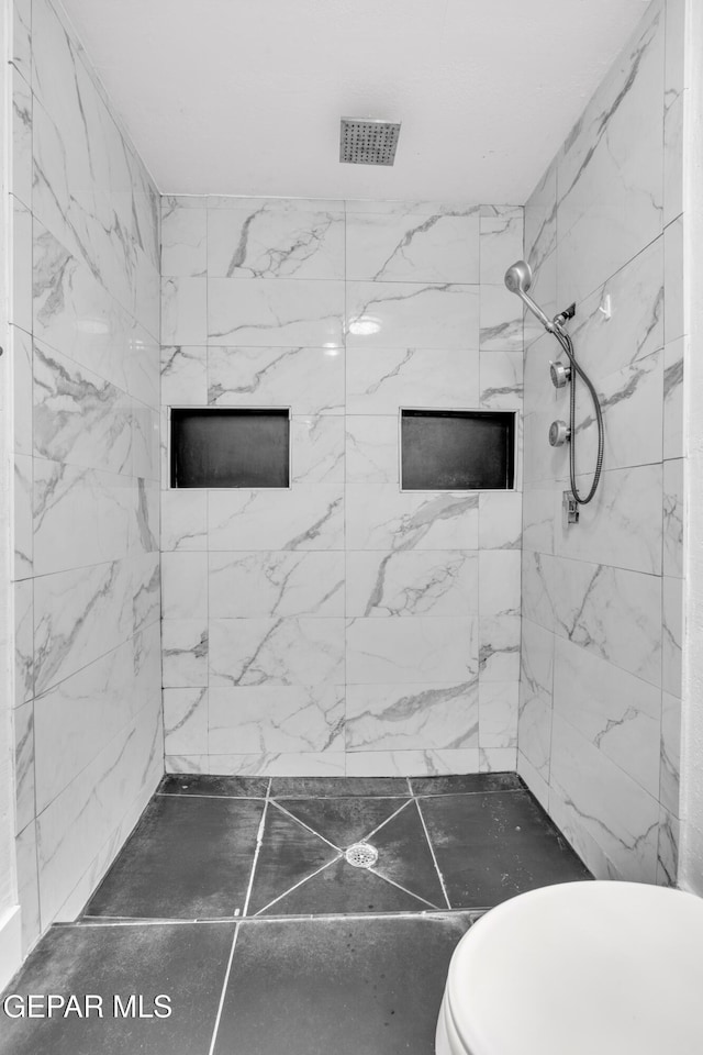 bathroom featuring toilet and a shower