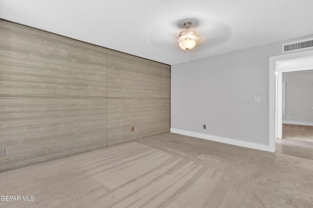 unfurnished room featuring carpet flooring, baseboards, and a ceiling fan