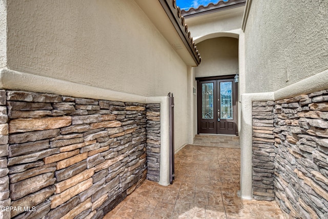1403 Franklin Dell St, El Paso, TX 79912 - entrance to property with french doors, stucco siding, and stone siding