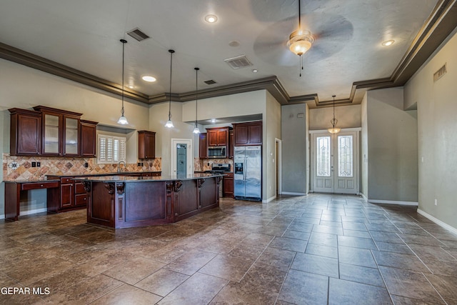 1403 Franklin Dell St, El Paso, TX 79912 - kitchen featuring stainless steel appliances, dark countertops, a kitchen island, backsplash, and ceiling fan