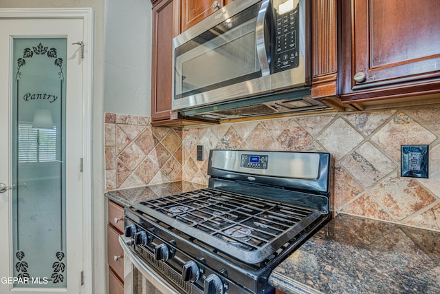 1403 Franklin Dell St, El Paso, TX 79912 - kitchen with appliances with stainless steel finishes, decorative backsplash, brown cabinetry, and dark stone counters