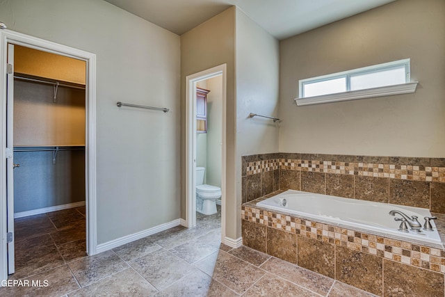 1403 Franklin Dell St, El Paso, TX 79912 - full bathroom featuring toilet, a bath, a spacious closet, and baseboards