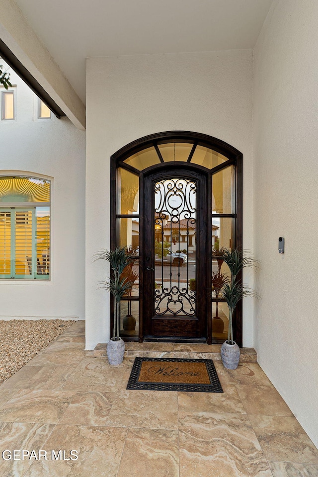 property entrance featuring stucco siding