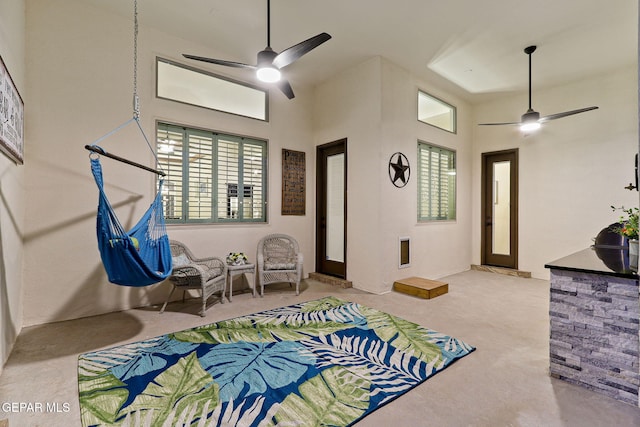 carpeted bedroom with a high ceiling and ceiling fan