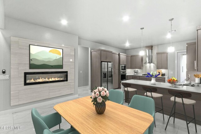 12627 Naes Way, El Paso, TX 79928 - dining room with light marble finish flooring, a glass covered fireplace, and baseboards