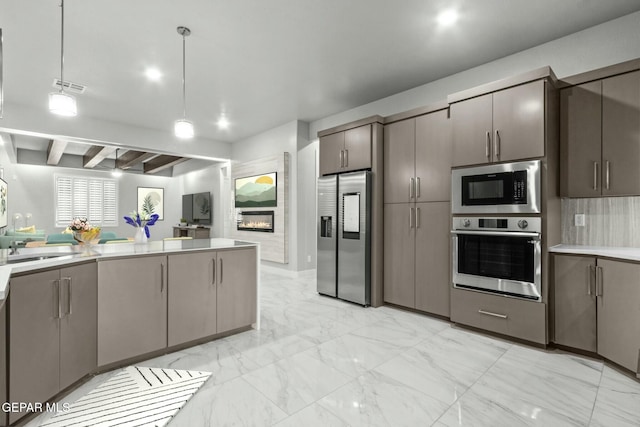 12627 Naes Way, El Paso, TX 79928 - kitchen featuring appliances with stainless steel finishes, light countertops, light marble finish floors, hanging light fixtures, and gray cabinets
