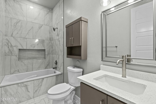 12627 Naes Way, El Paso, TX 79928 - full bath featuring marble look tiles, a combined bath / shower with marble appearance, toilet, and vanity