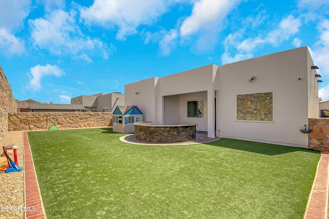 back of property featuring stucco siding