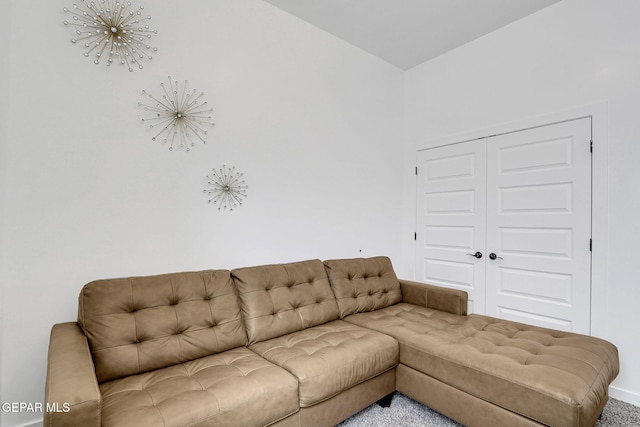 carpeted living room with baseboards