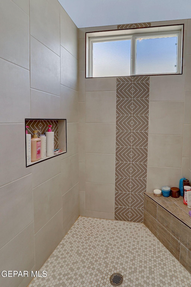 bathroom with tiled shower