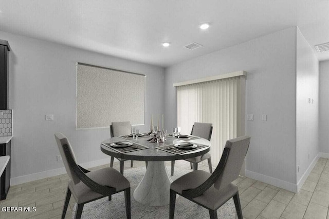 dining space featuring baseboards and recessed lighting