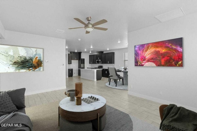living room with ceiling fan and recessed lighting