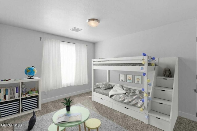 bedroom with carpet floors and baseboards