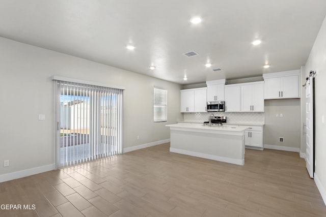 7465 Big Mountain Ct, El Paso, TX 79911 - kitchen with stainless steel appliances, tasteful backsplash, light countertops, white cabinetry, and recessed lighting