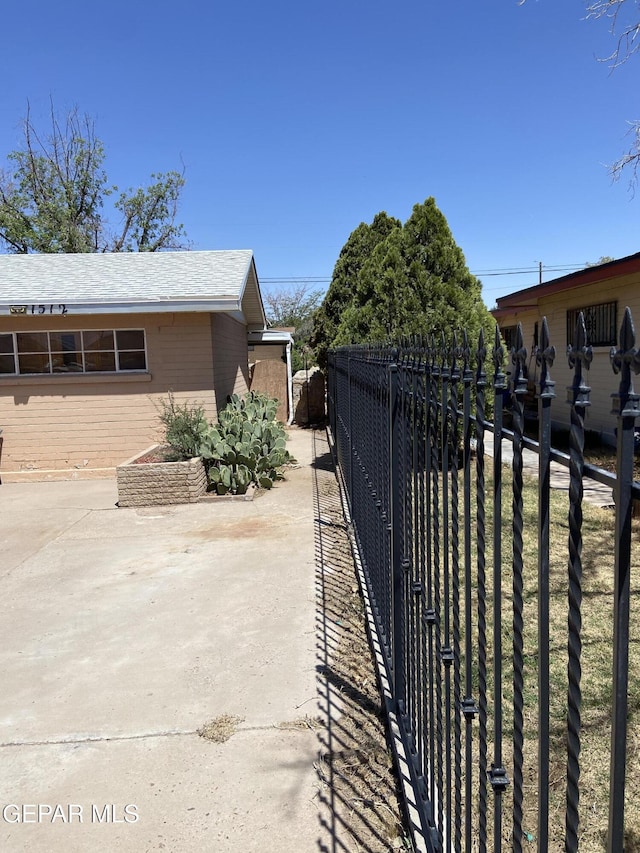 view of side of property featuring fence and a patio