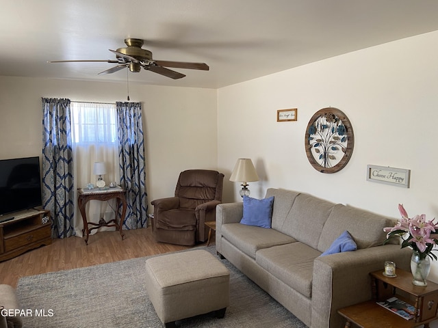 living room with wood finished floors and a ceiling fan