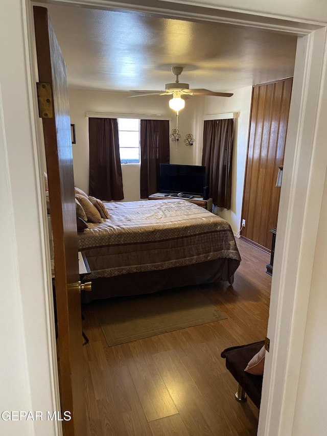 bedroom featuring wood finished floors and ceiling fan