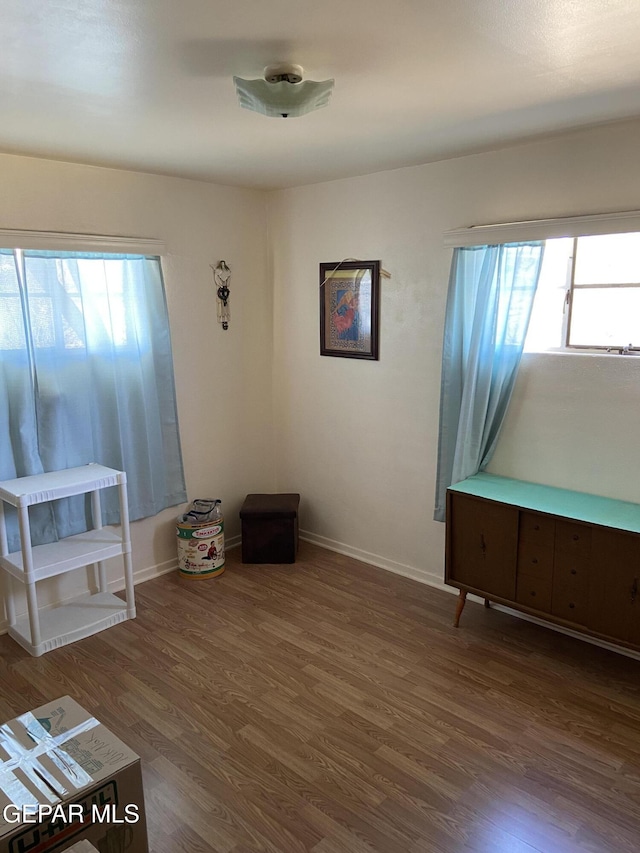 unfurnished room featuring wood finished floors and baseboards