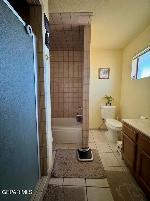 full bathroom with toilet, tile patterned floors, and vanity