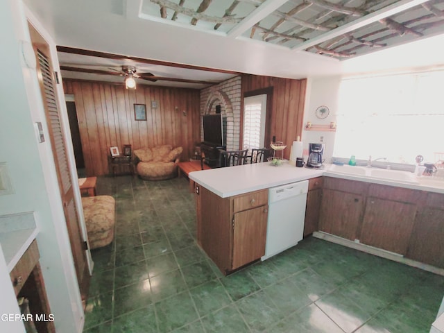 3433 Dialrock Ln, El Paso, TX 79935 - kitchen with dishwasher, wooden walls, a sink, a peninsula, and open floor plan