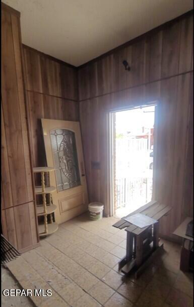 3433 Dialrock Ln, El Paso, TX 79935 - dining area featuring wood walls