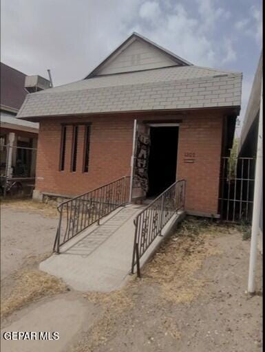 3433 Dialrock Ln, El Paso, TX 79935 - view of front of home with brick siding and a shingled roof