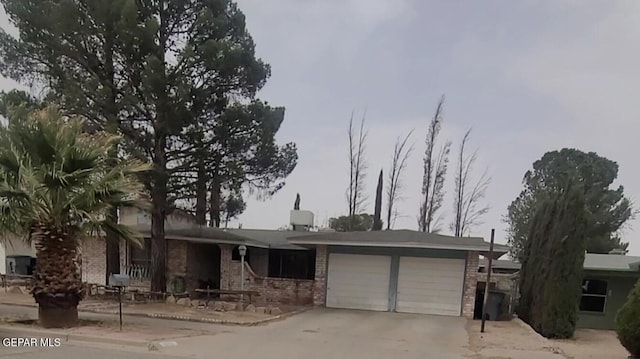 3433 Dialrock Ln, El Paso, TX 79935 - ranch-style home with brick siding, an attached garage, and concrete driveway