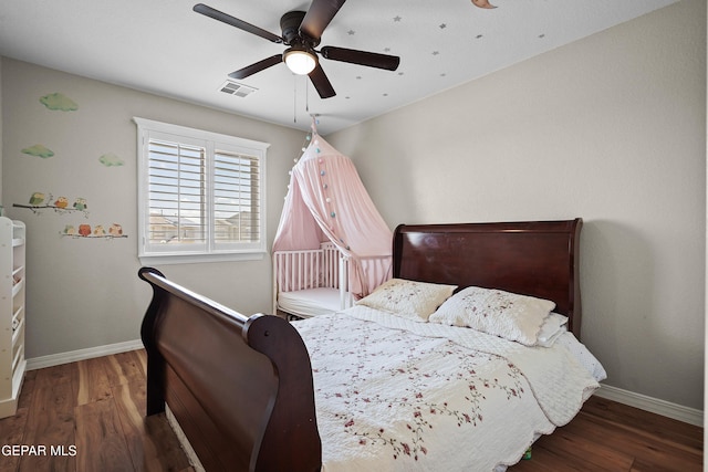 bedroom with baseboards, wood finished floors, and ceiling fan