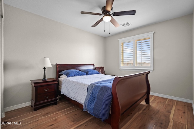bedroom featuring baseboards, hardwood / wood-style floors, and a ceiling fan