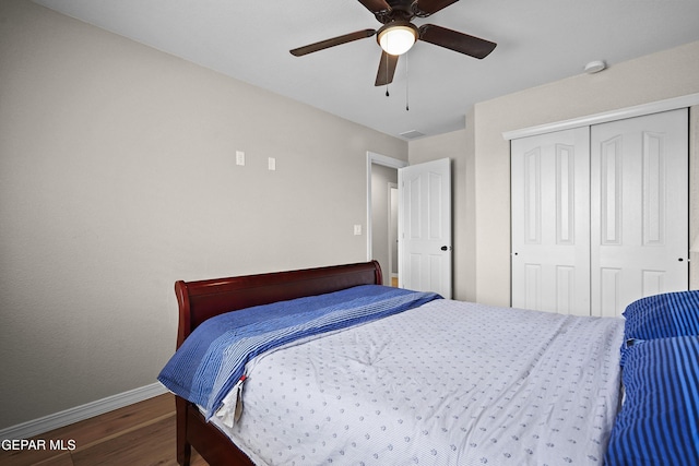 bedroom featuring baseboards, wood finished floors, a closet, and ceiling fan