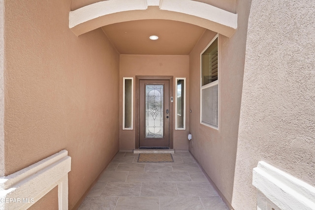 doorway to property with stucco siding