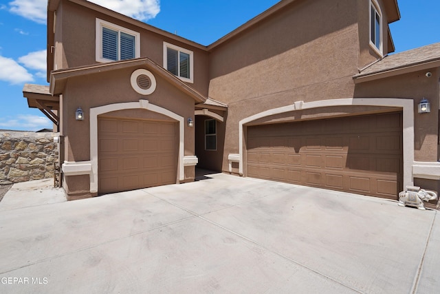 view of front of home with stucco siding and concrete driveway