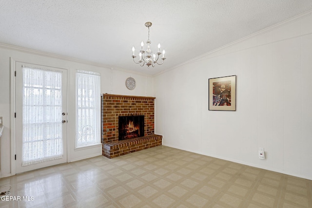 unfurnished living room with healthy amount of natural light, a chandelier, tile patterned floors, ornamental molding, and a brick fireplace