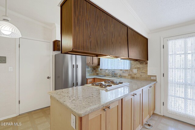 kitchen with high quality fridge, white cooktop, light flooring, a sink, and a peninsula