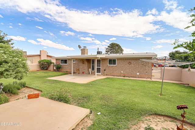 back of property featuring a patio area, brick siding, and a chimney