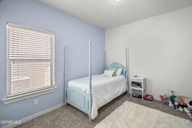 carpeted bedroom featuring baseboards