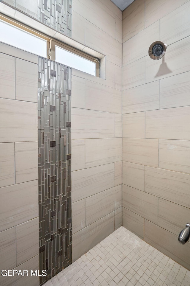 bathroom with tiled shower