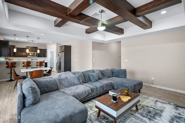 living area featuring coffered ceiling, beamed ceiling, baseboards, ceiling fan, and recessed lighting
