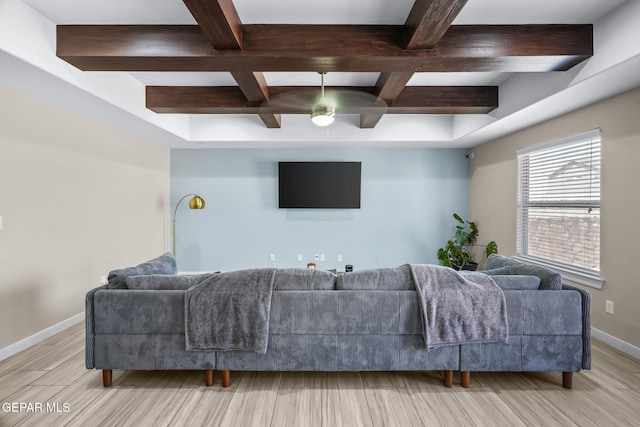 living area featuring baseboards, coffered ceiling, beam ceiling, a ceiling fan, and light wood-style flooring