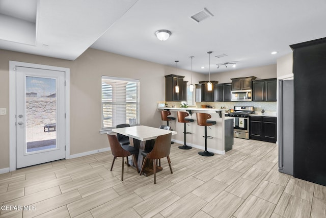 dining room with wood tiled floors and baseboards