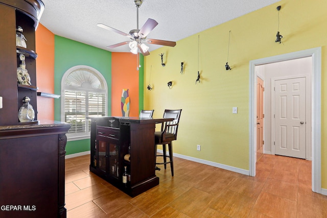 7008 Desert Canyon Dr, El Paso, TX 79912 - dining space featuring a ceiling fan, a textured ceiling, and baseboards