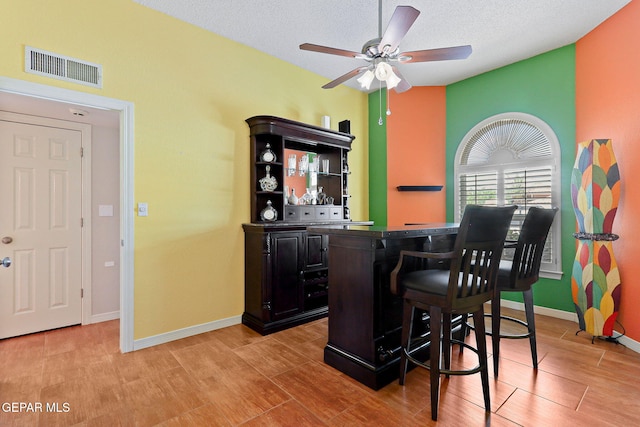 7008 Desert Canyon Dr, El Paso, TX 79912 - bar featuring ceiling fan, light wood-type flooring, baseboards, and a textured ceiling