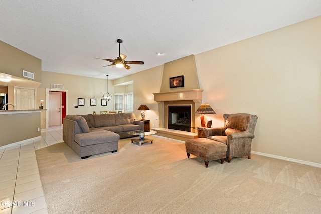 7008 Desert Canyon Dr, El Paso, TX 79912 - living room featuring a fireplace, a ceiling fan, baseboards, and light carpet