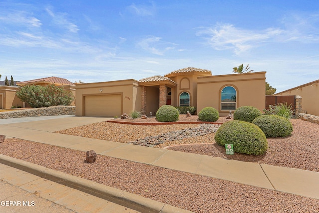 7008 Desert Canyon Dr, El Paso, TX 79912 - mediterranean / spanish-style house with a garage, stucco siding, driveway, a tile roof, and fence