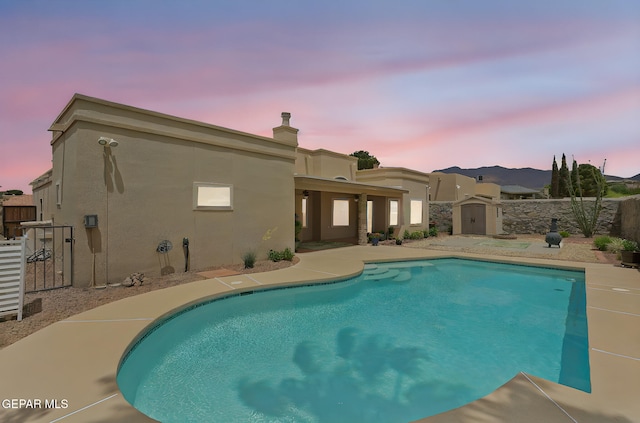 7008 Desert Canyon Dr, El Paso, TX 79912 - view of pool with a storage shed, an outdoor structure, a fenced backyard, and a patio