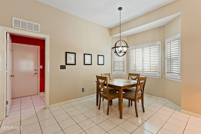 7008 Desert Canyon Dr, El Paso, TX 79912 - dining area featuring a chandelier, light tile patterned floors, and baseboards